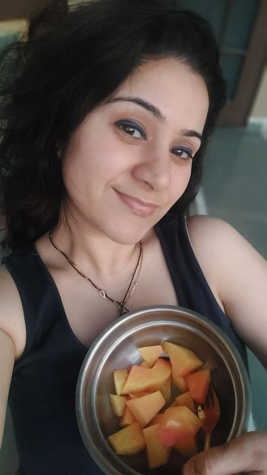 Charu Wadhwa holding a bowl of fresh fruit