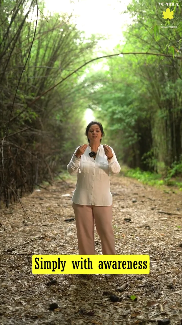 A retreat host on a forest path in the Mussoorie hills, welcoming guests