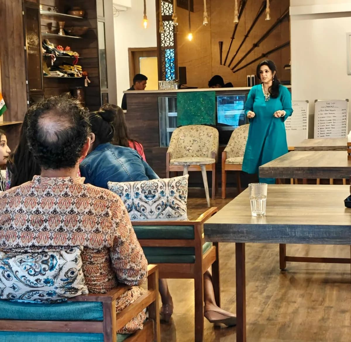 Charu Wadhwa taking a Face Yoga session for a seated audience at VOW Café, Dehradun